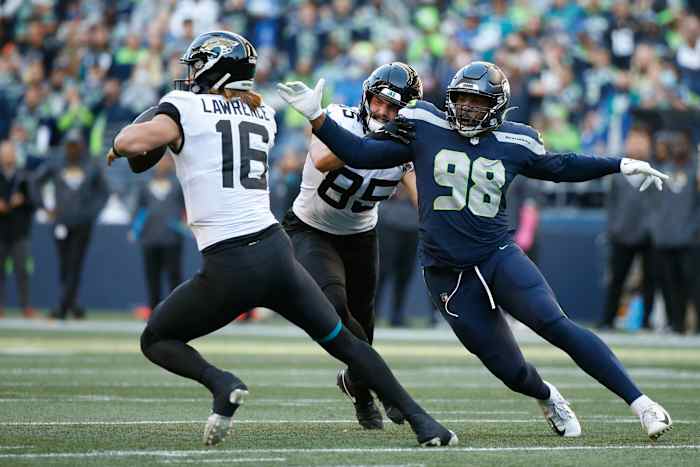 Seattle Seahawks linebacker Alton Robinson (98) pressures the quarterback against Jacksonville Jaguars tight end Dan Arnold (85) during the fourth quarter at Lumen Field.